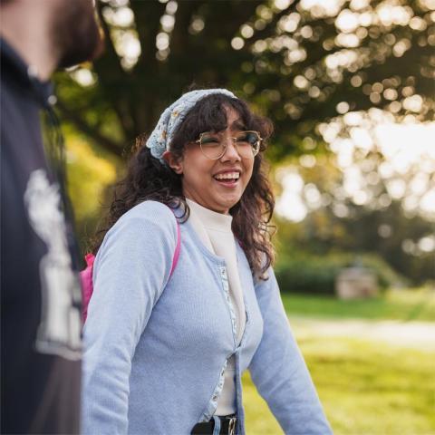 Female student smiling walking outside on campus